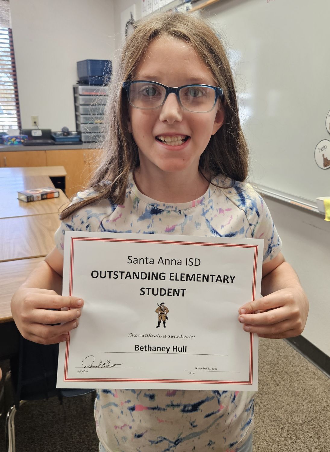 young girl wearing glasses with smile holding certificate